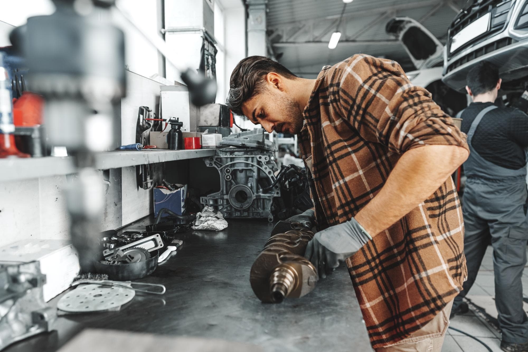 Mechanic working on a car engine in the shop