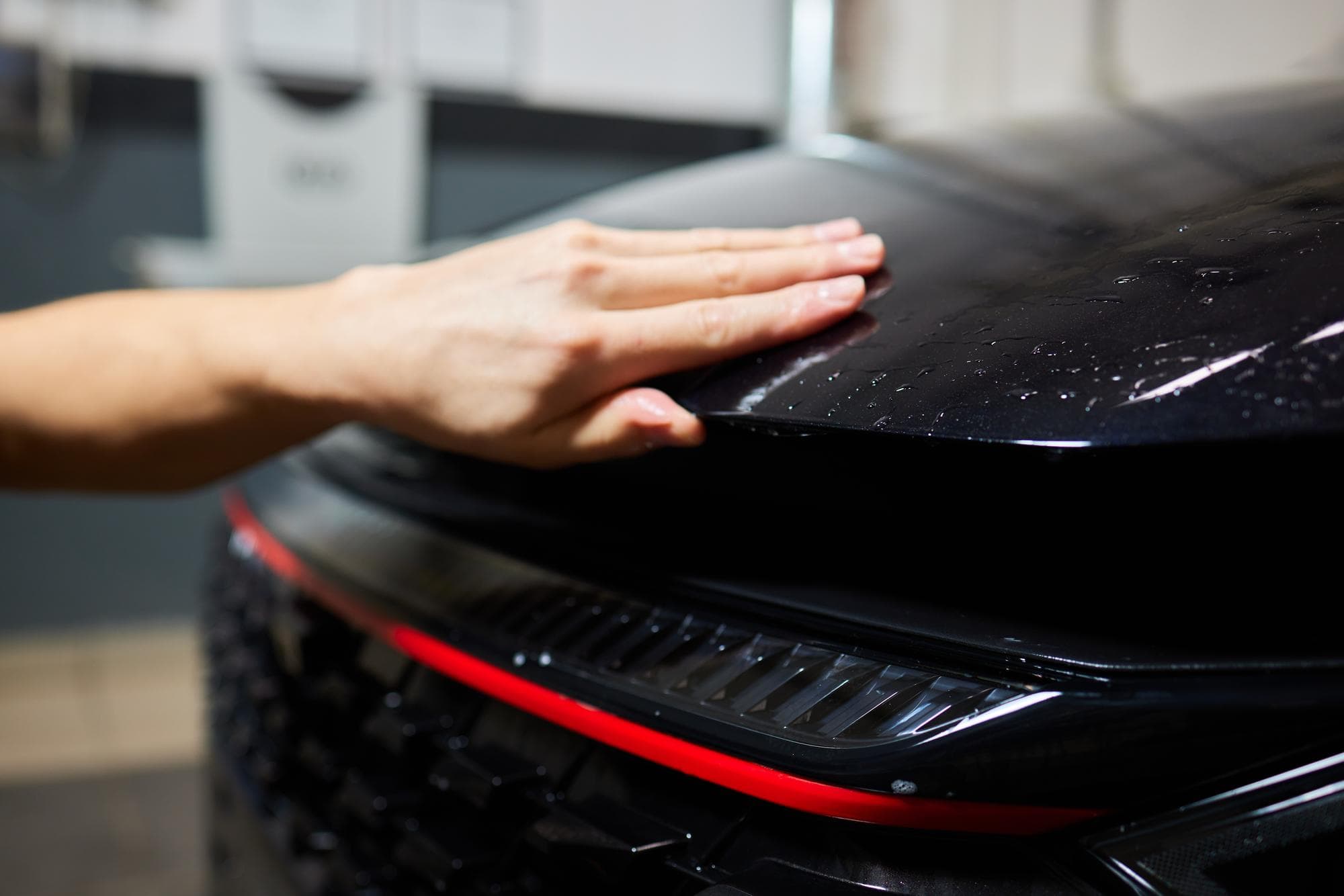 Clear paint protection film being installed on a car